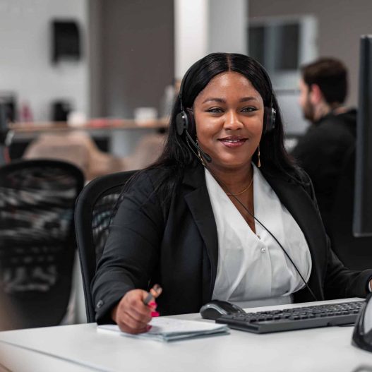 Customer service representative with headset smiling in the camera